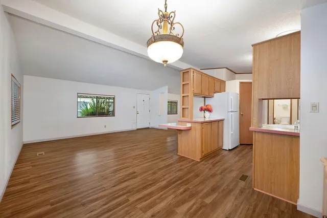 a kitchen with a wooden floor and window