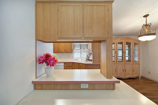 a kitchen with a refrigerator and a table