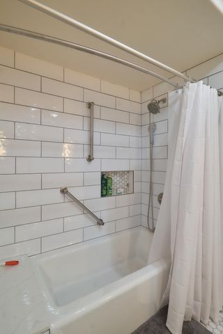 a bathroom with a bathtub and shower