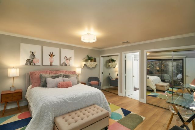 a bedroom with a bed and a mirror