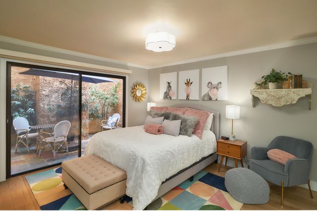 a bedroom with a bed and a balcony view