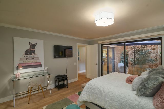 a bedroom with a bed and glass window