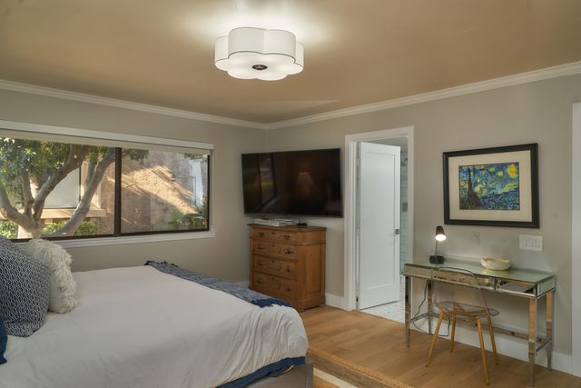 a bedroom with a bed and a flat screen tv