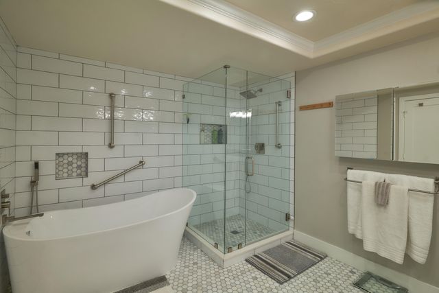a bathroom with a bathtub and shower