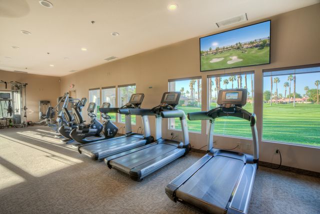 a room with gym equipment and a large window