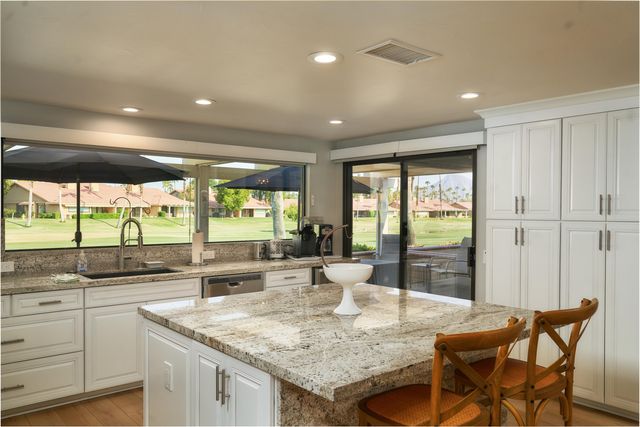 a kitchen with granite countertop sink and island