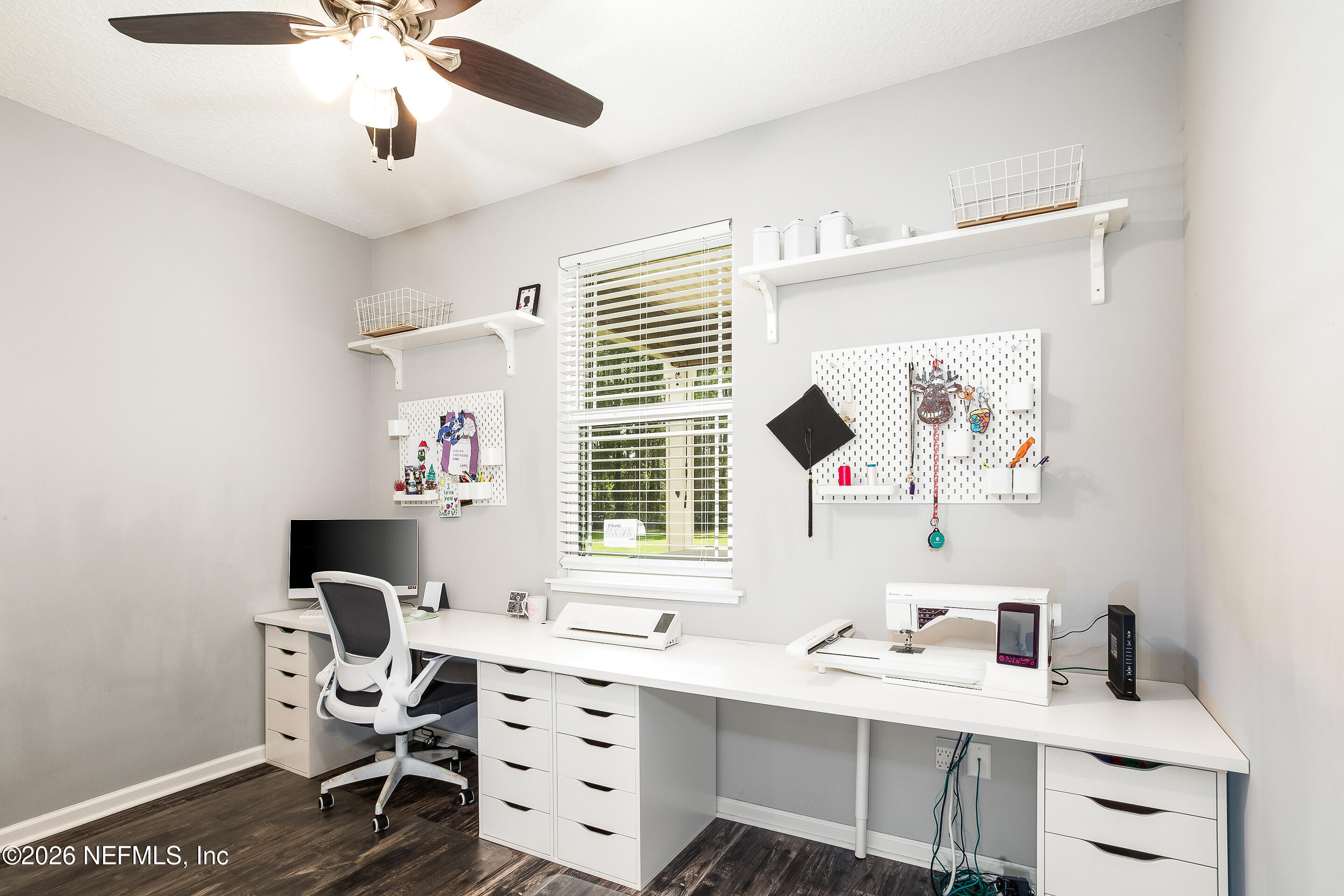 26575 Sheared Stokes Road Hilliard, FL 32046 - Photo 17 of 39 a view of a workspace with furniture and a window