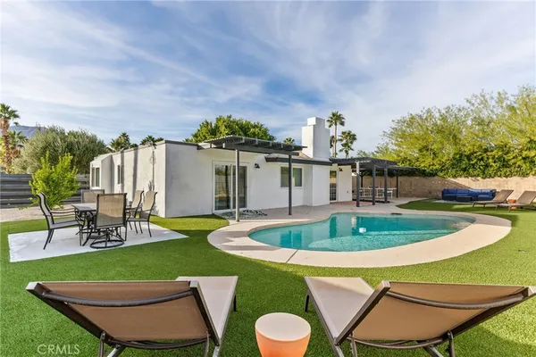 a view of a swimming pool and chairs in patio