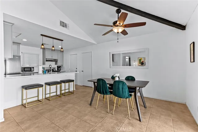 a kitchen with stainless steel appliances a sink a stove and cabinets
