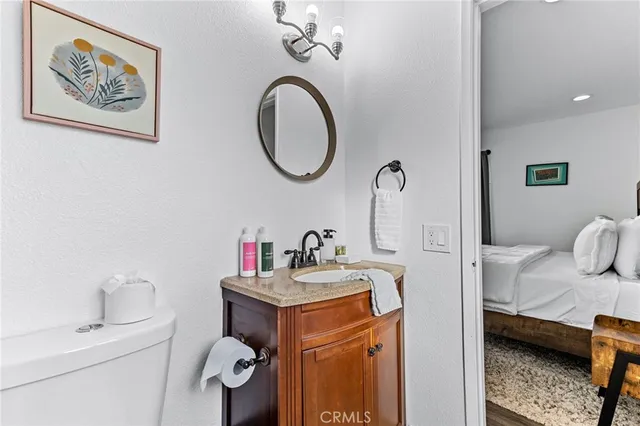 a bedroom with a bed and painting on the wall