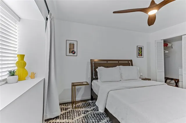 a bathroom with a toilet sink vanity and mirror