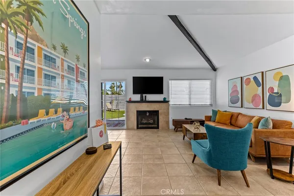 a living room with furniture and a wall painting