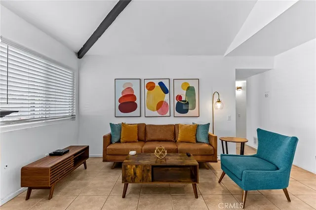 a dining room with furniture and a chandelier fan