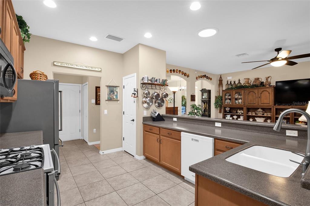 16411 Southwest 14th Avenue Road Ocala, FL 34473 - Photo 28 of 59 a kitchen with stainless steel appliances granite countertop a refrigerator and a stove top oven