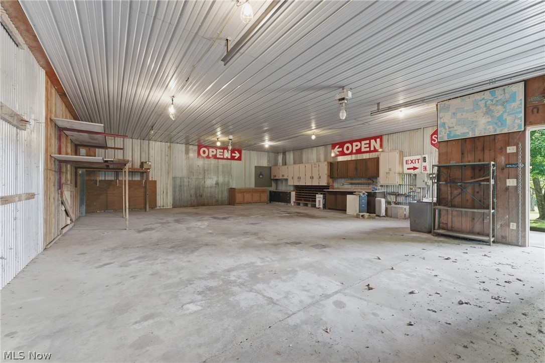 2184 Brenner Road Northeast Carrollton, OH 44615 - Photo 47 of 50 Expansive interior space featuring a concrete floor, corrugated metal walls, and a corrugated metal ceiling