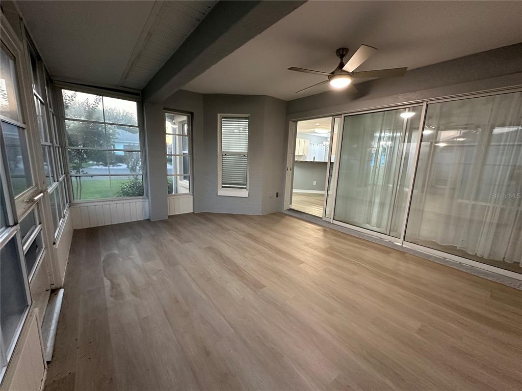 9706 Southwest 92nd Place Road Ocala, FL 34481 - Photo 27 of 82 an empty room with wooden floor and windows