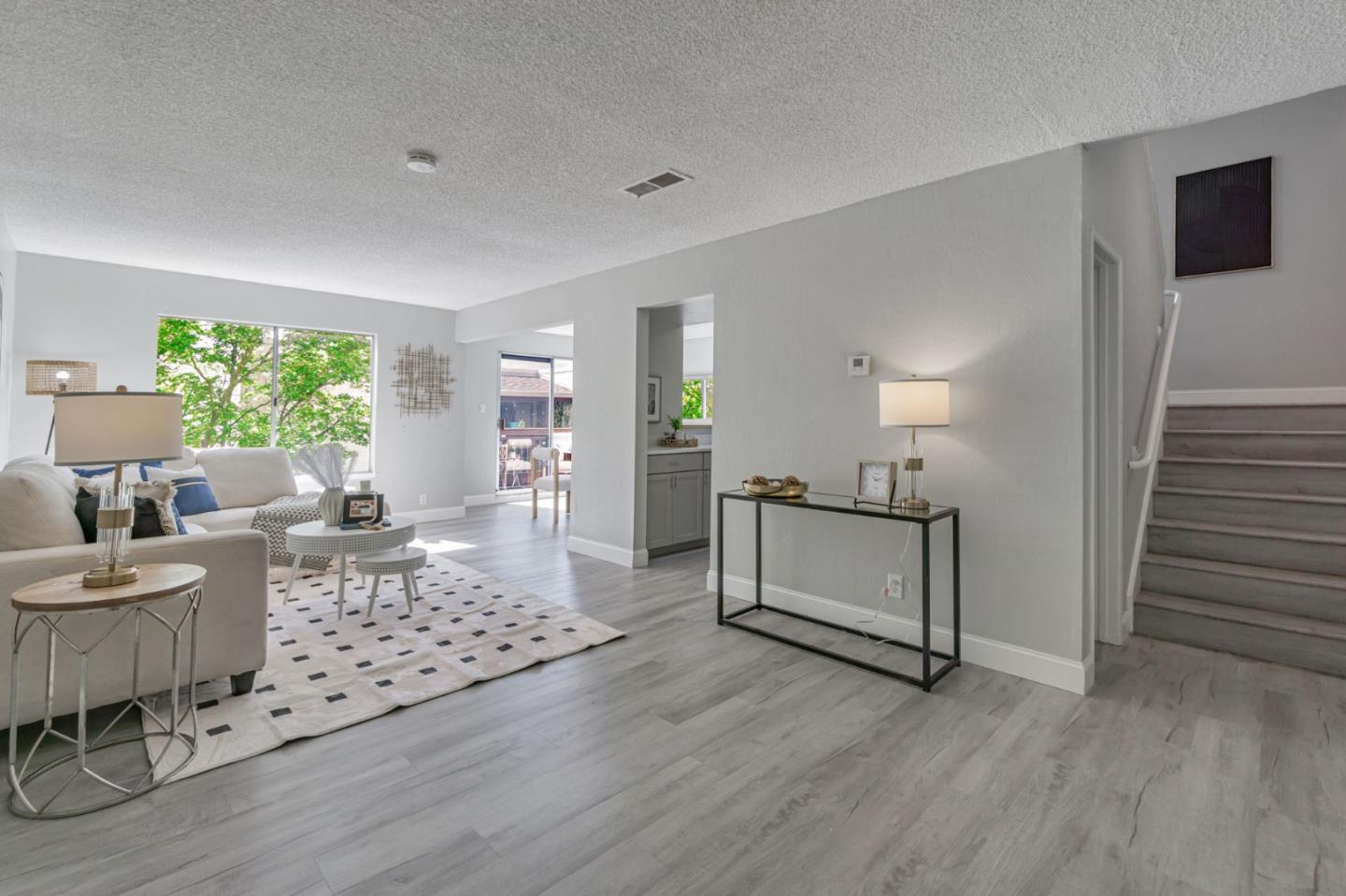 1680 Laguna Street, Unit H Concord, CA 94520 - Photo 1 of 12 a living room with furniture and a wooden floor