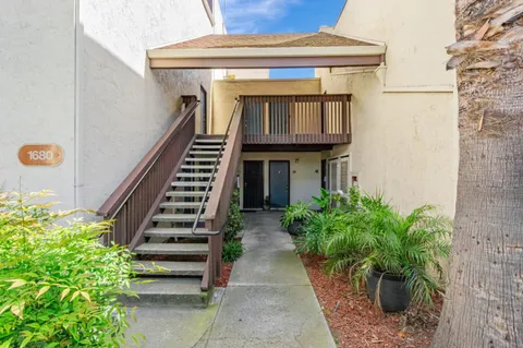 a front view of a house with plants