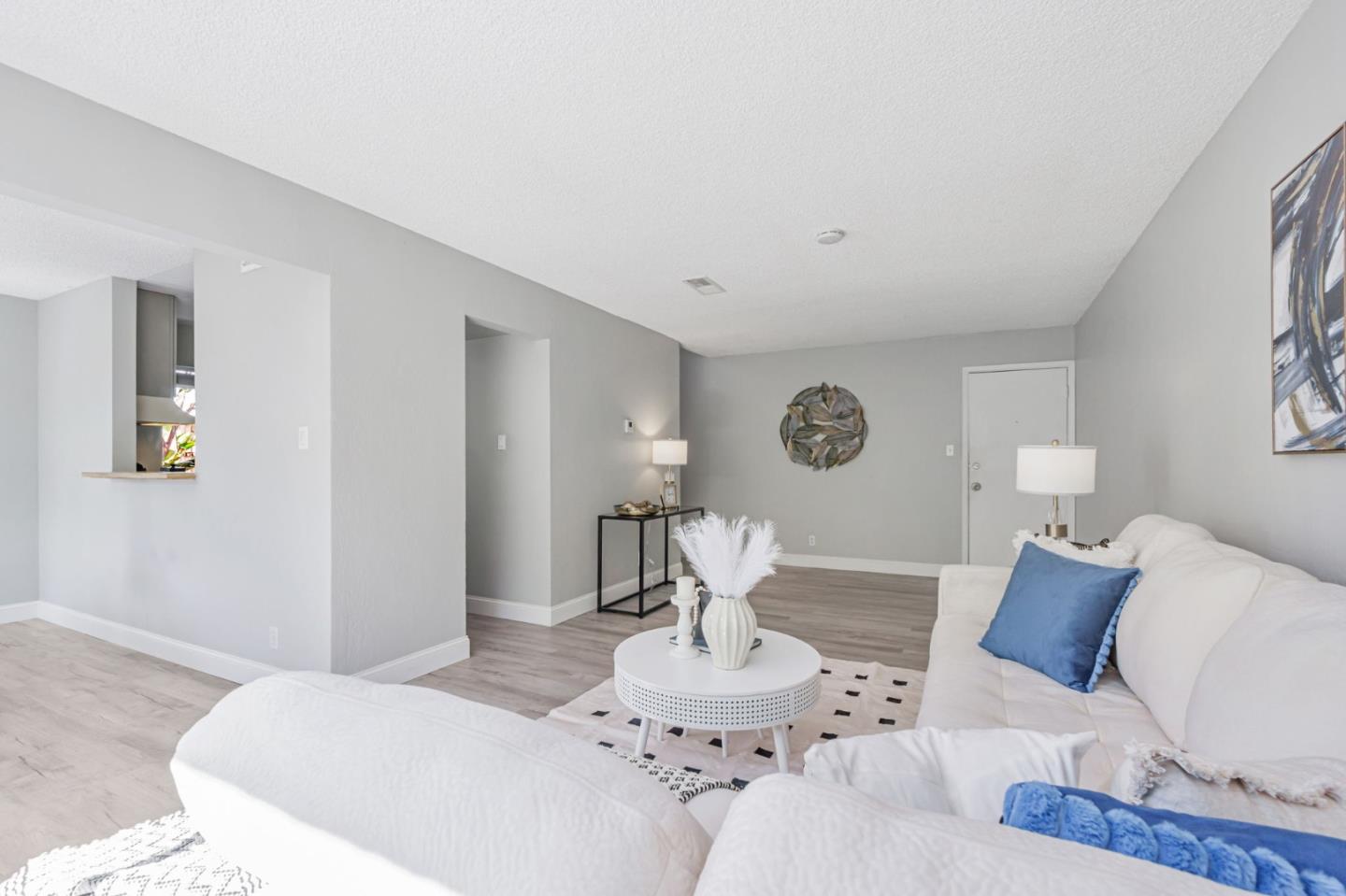 1680 Laguna Street, Unit H Concord, CA 94520 - Photo 2 of 12 a living room with furniture and a table