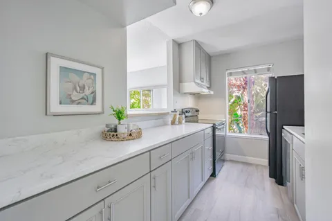 a kitchen with a refrigerator and a sink