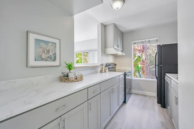 a kitchen with a refrigerator and a sink