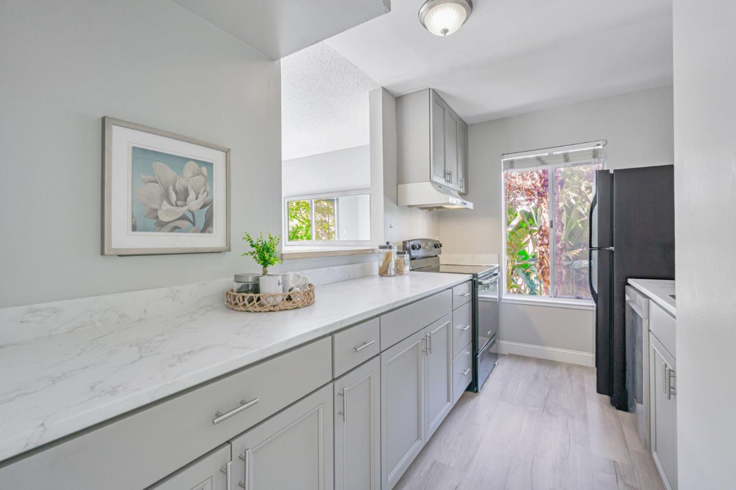 1680 Laguna Street, Unit H Concord, CA 94520 - Photo 3 of 12 a kitchen with a refrigerator and a sink
