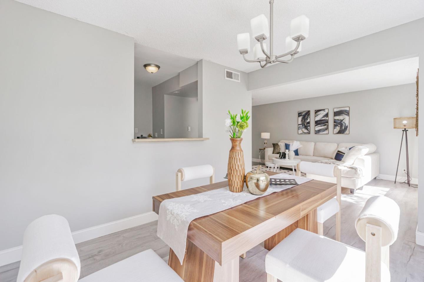 1680 Laguna Street, Unit H Concord, CA 94520 - Photo 5 of 12 a bedroom with a bed and chandelier