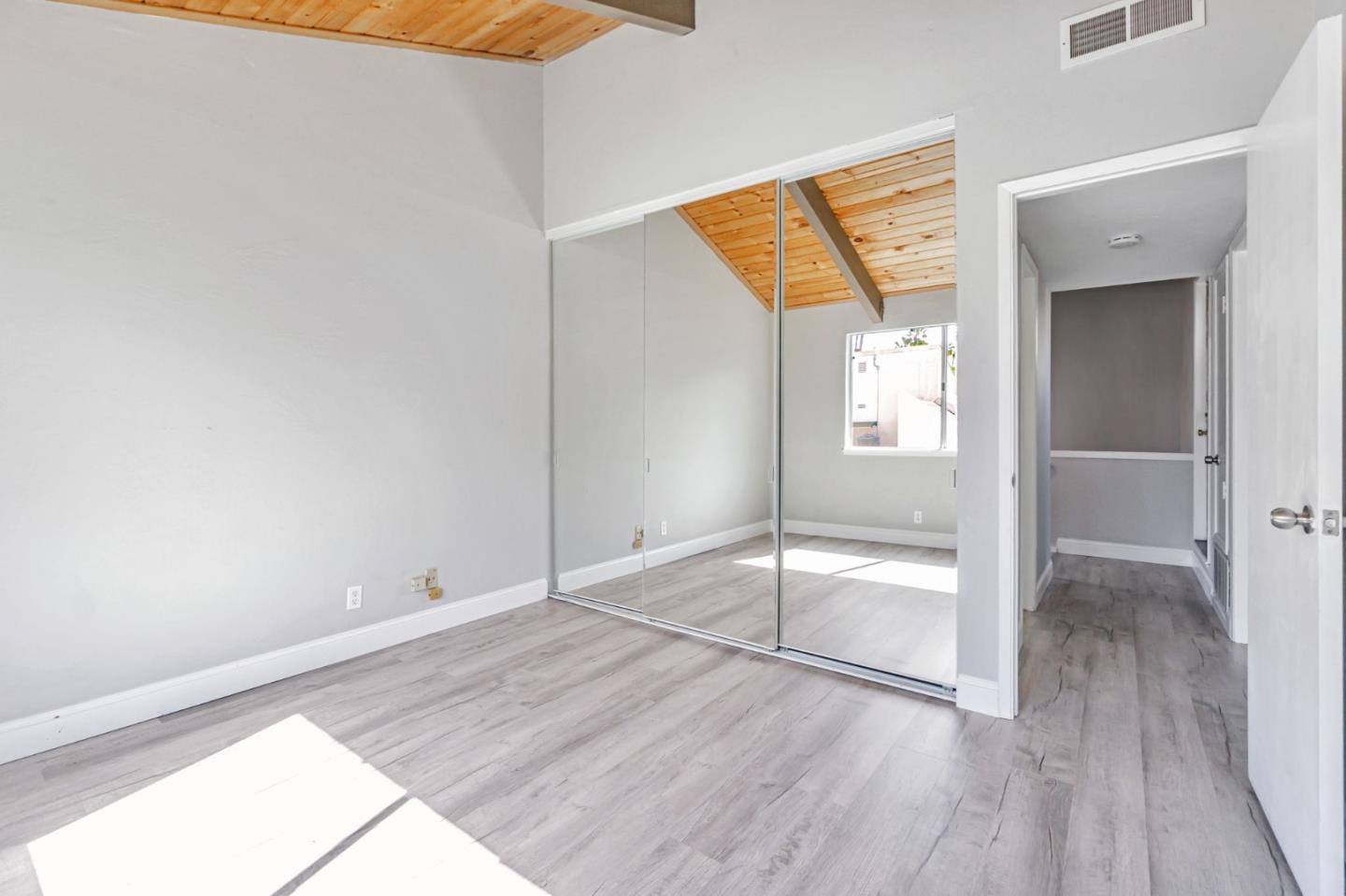 1680 Laguna Street, Unit H Concord, CA 94520 - Photo 7 of 12 an empty room with wooden floor and door