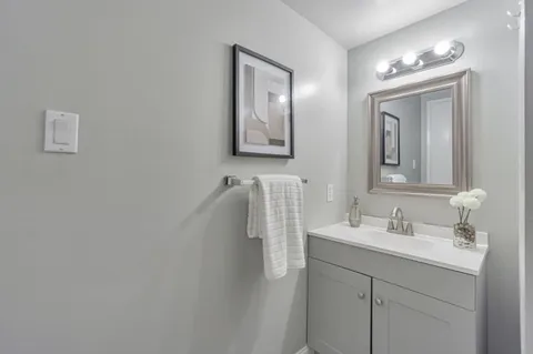 a bathroom with double vanity sink and mirror