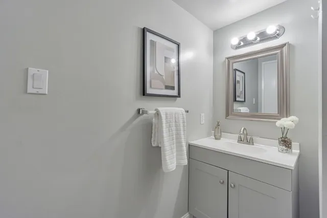 a bathroom with double vanity sink and mirror