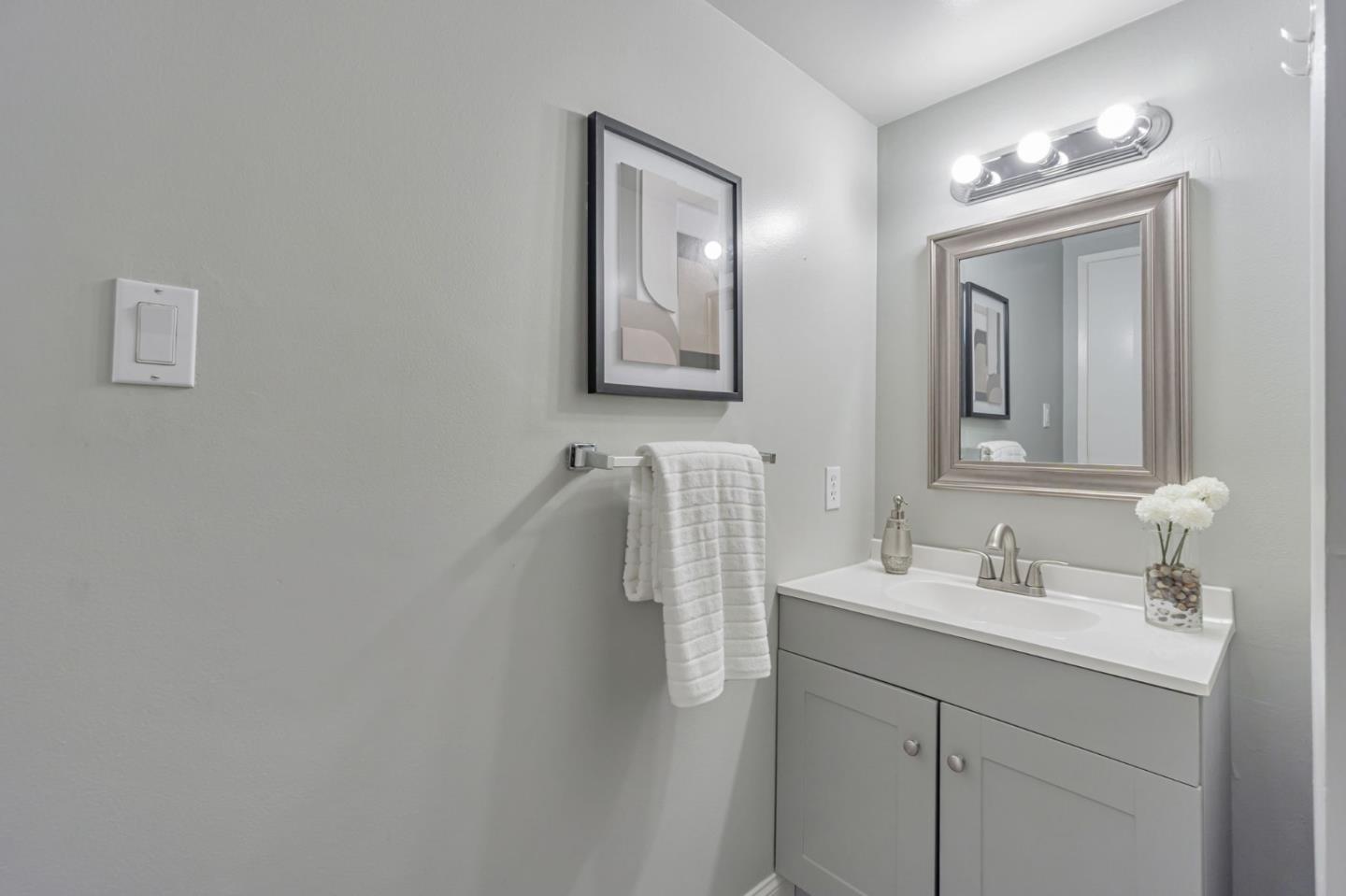 1680 Laguna Street, Unit H Concord, CA 94520 - Photo 9 of 12 a bathroom with double vanity sink and mirror