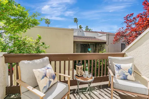 a view of balcony with furniture