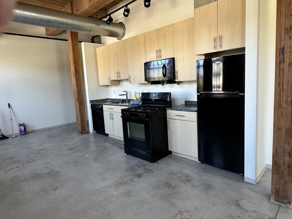 88 Gerrish Avenue, Unit 207 Chelsea, MA 02150 - Photo 1 of 10 a kitchen with a sink stainless steel appliances and cabinets