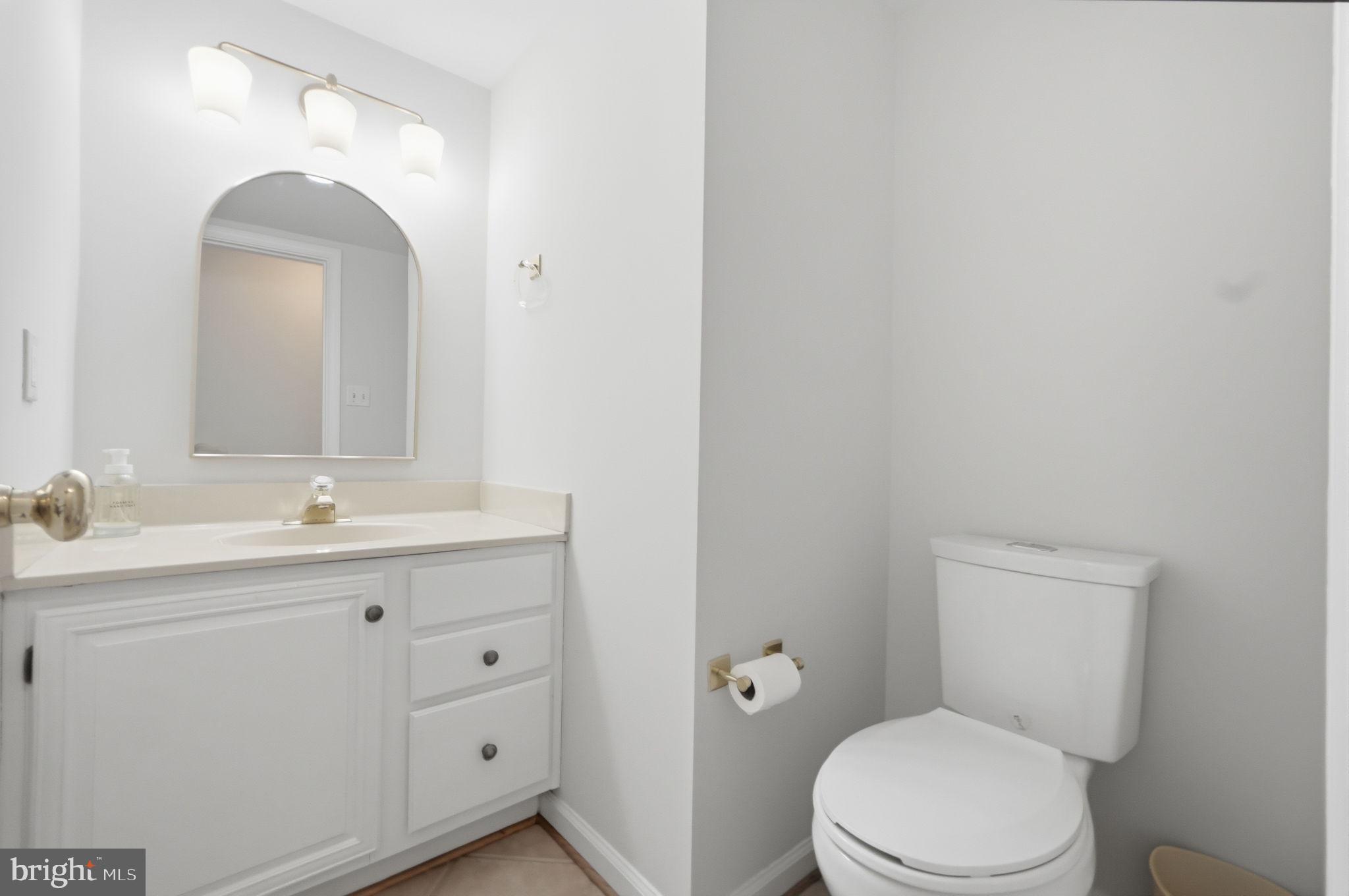 7504 Mullingar Court Springfield, VA 22153 - Photo 17 of 60 a bathroom with a granite countertop toilet a sink and mirror