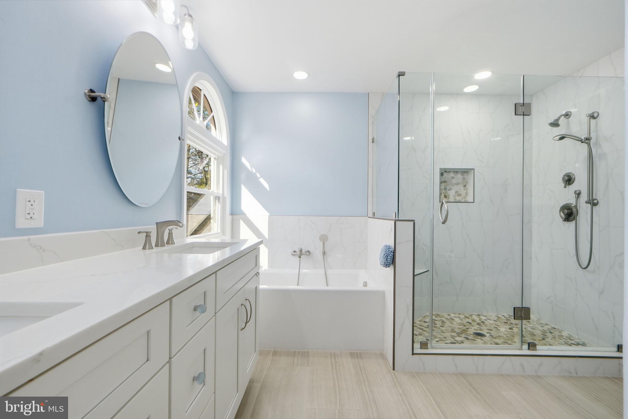 7504 Mullingar Court Springfield, VA 22153 - Photo 28 of 60 a bathroom with a double vanity sink mirror and shower