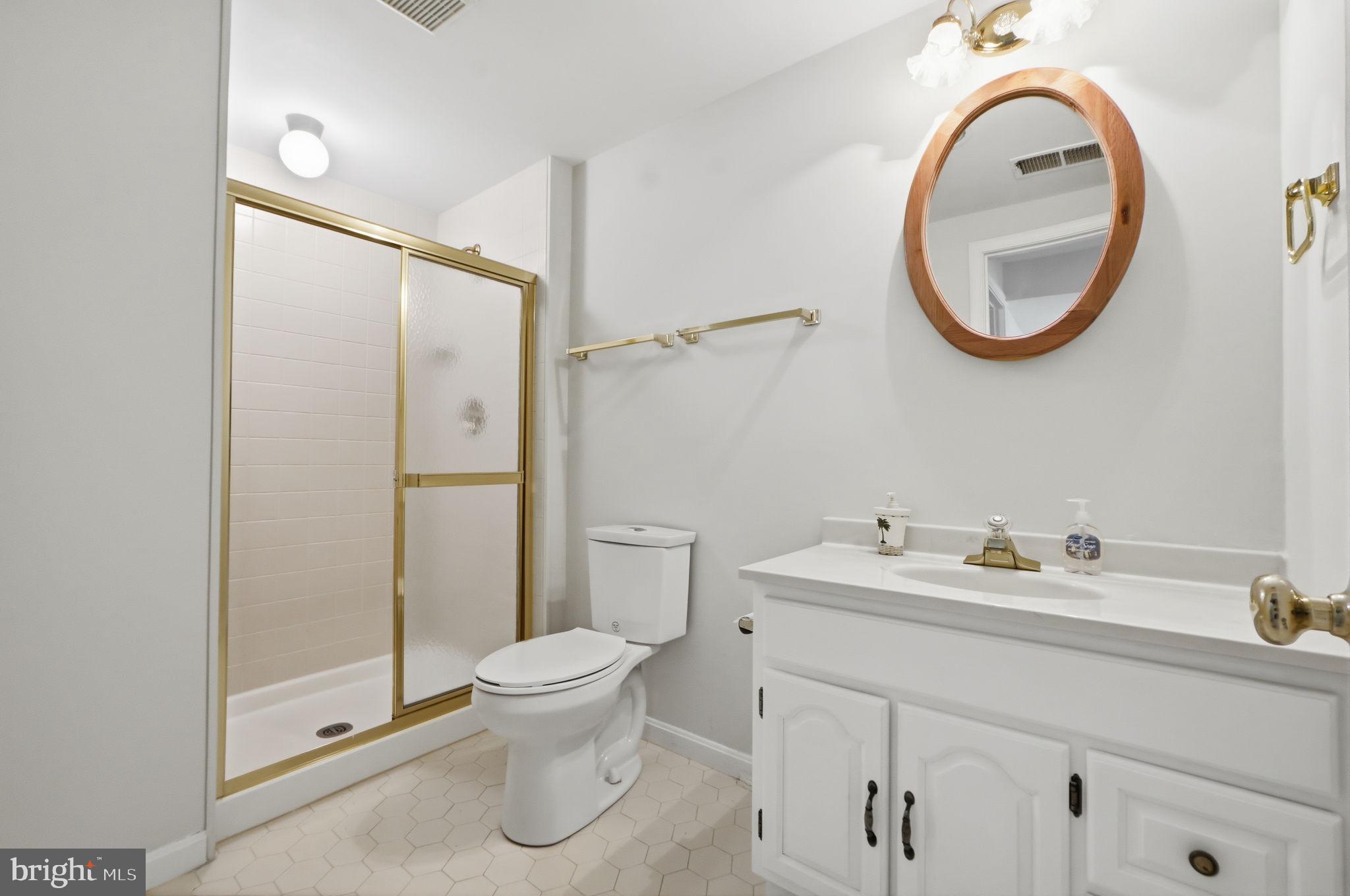 7504 Mullingar Court Springfield, VA 22153 - Photo 47 of 60 a bathroom with a toilet sink and a mirror