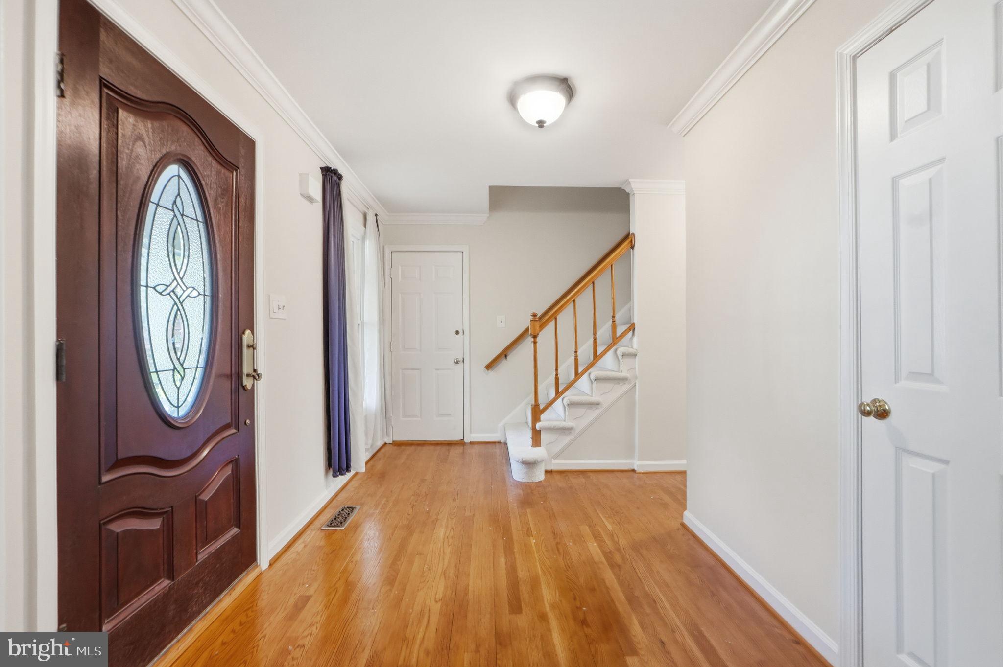 7504 Mullingar Court Springfield, VA 22153 - Photo 5 of 60 a view of a hallway with wooden floor and entryway