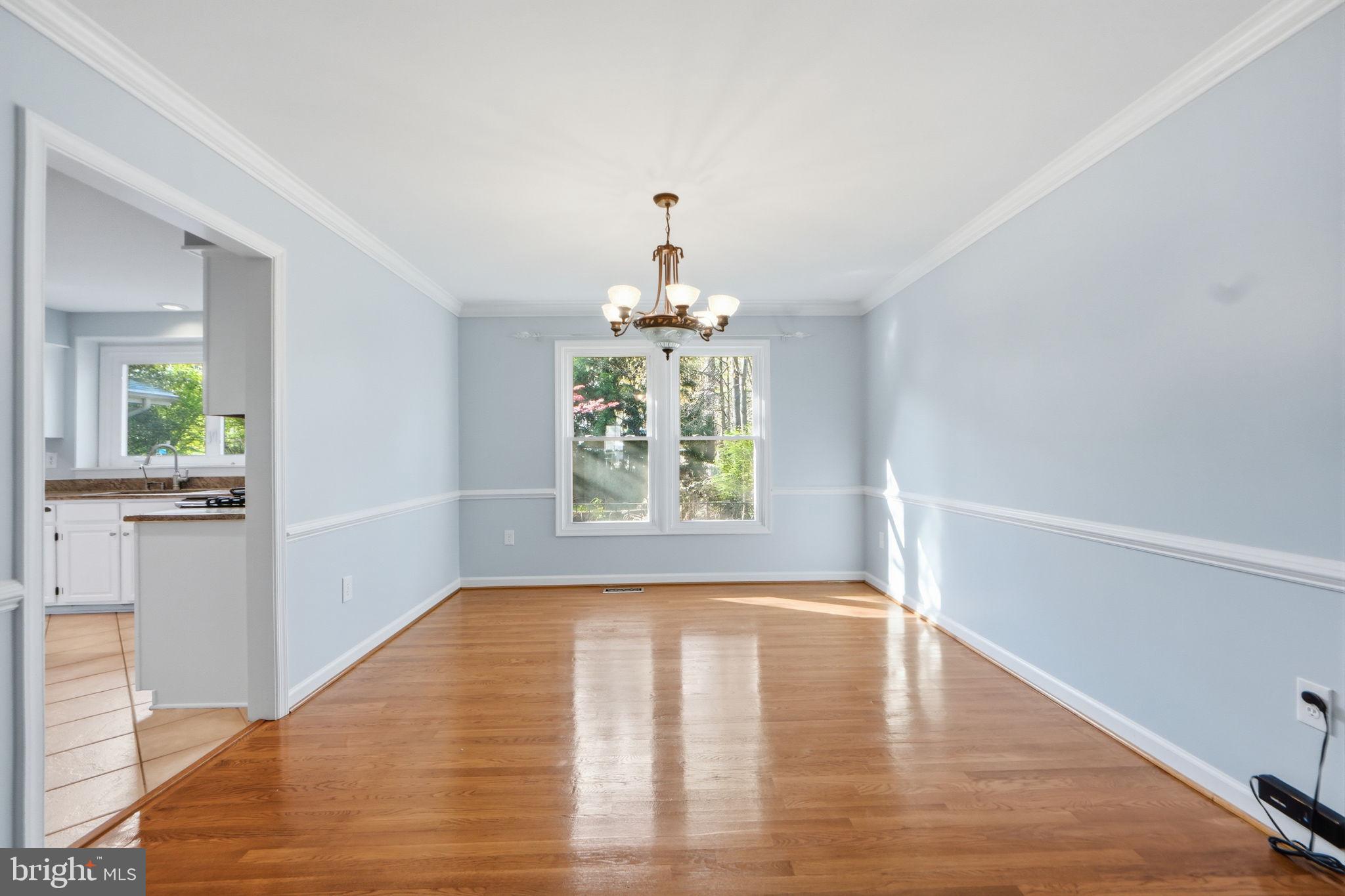 7504 Mullingar Court Springfield, VA 22153 - Photo 9 of 60 a view of an empty room with wooden floor and a window
