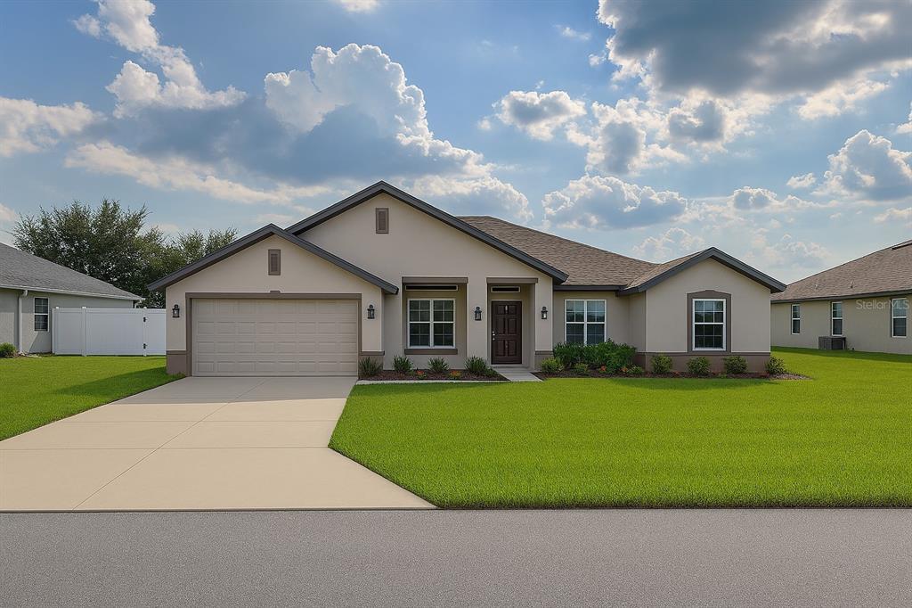 9148 Southeast 49th Avenue Road Ocala, FL 34480 - Photo 1 of 22 a front view of a house with a yard and garage