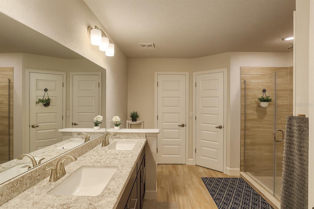 9148 Southeast 49th Avenue Road Ocala, FL 34480 - Photo 12 of 22 a bathroom with a granite countertop sink mirror vanity and shower