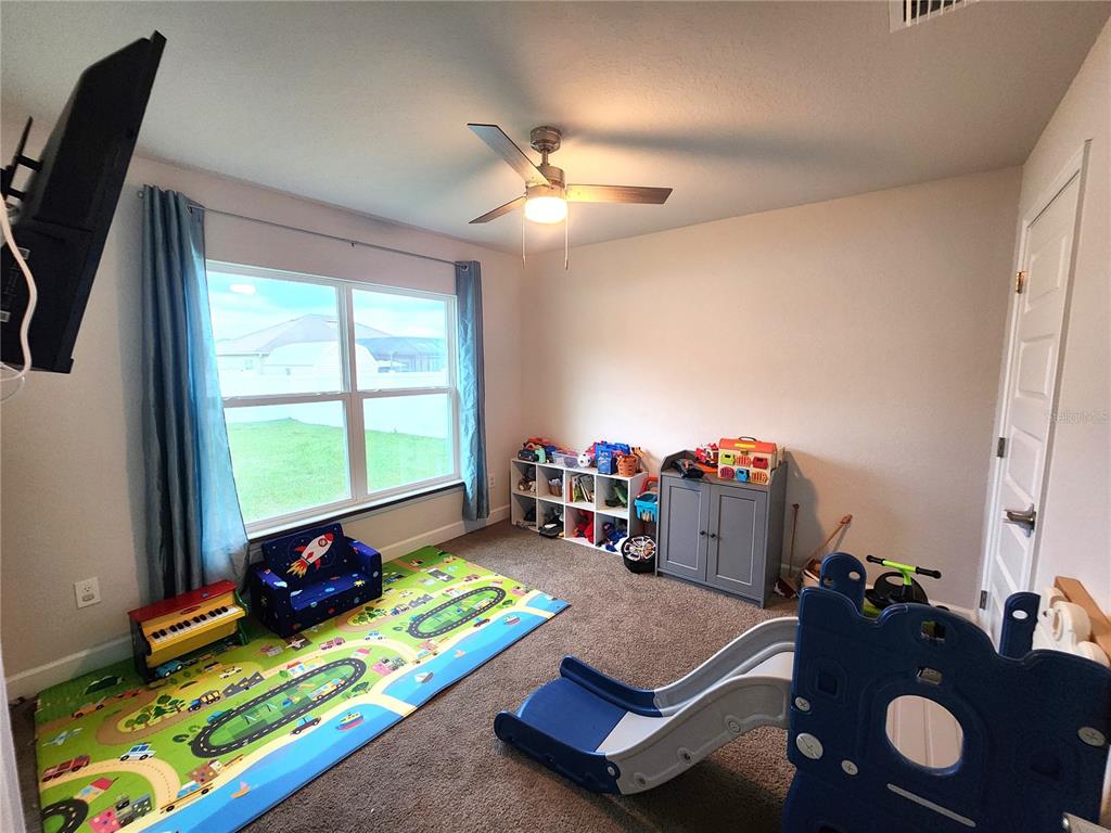 9148 Southeast 49th Avenue Road Ocala, FL 34480 - Photo 16 of 22 a bed room with furniture and a window