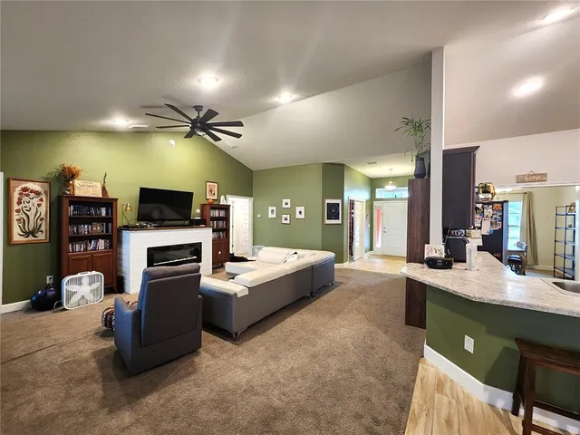 a living room with granite countertop furniture and a flat screen tv
