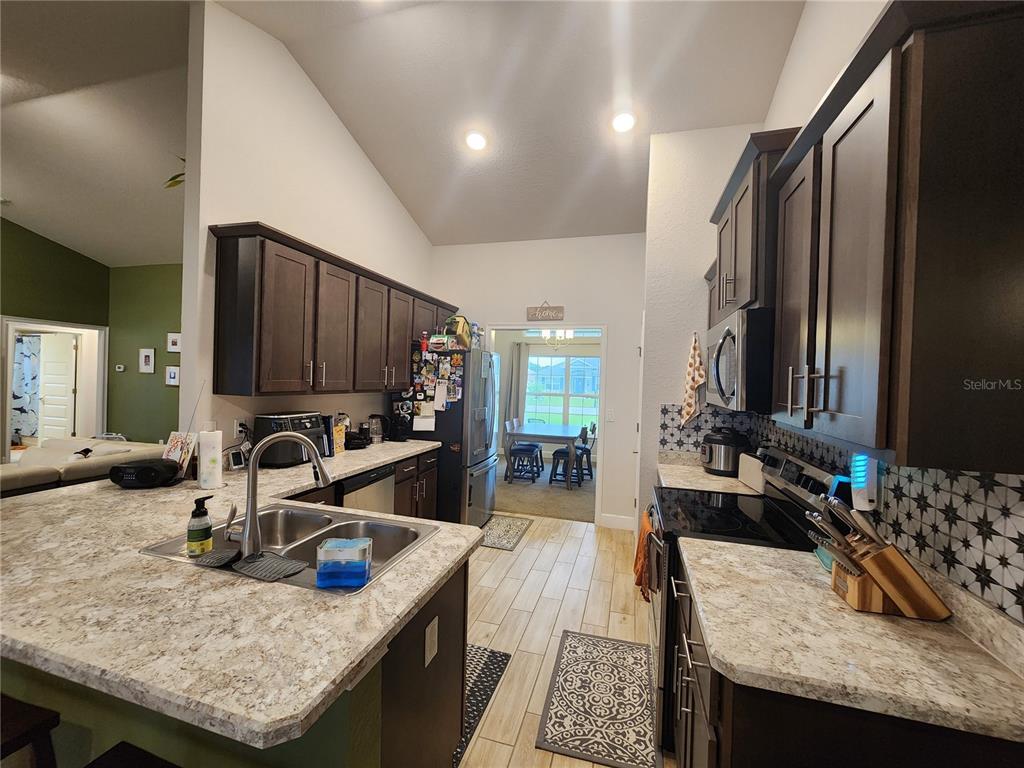 9148 Southeast 49th Avenue Road Ocala, FL 34480 - Photo 8 of 22 a living room with granite countertop furniture and a flat screen tv