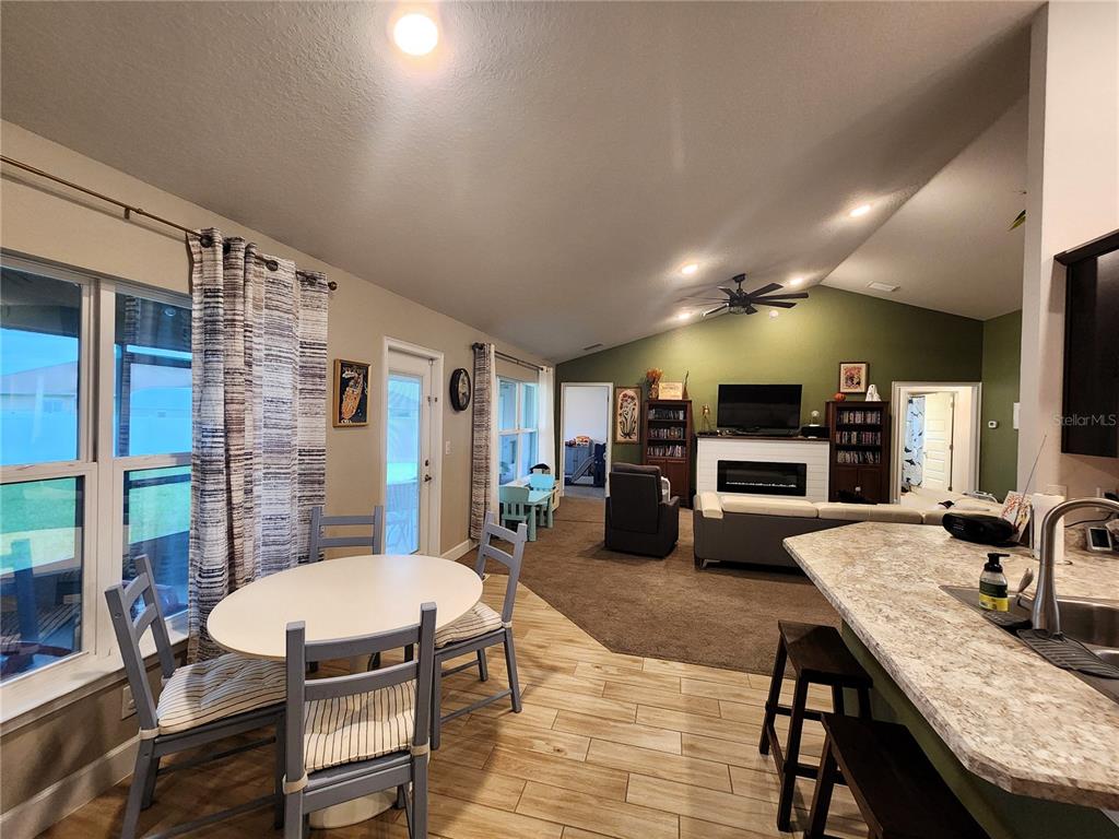 9148 Southeast 49th Avenue Road Ocala, FL 34480 - Photo 9 of 22 a kitchen with sink stove dining table and chairs