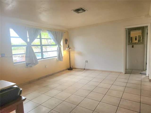 a view of an empty room and window