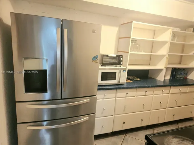 a kitchen with stainless steel appliances and cabinets