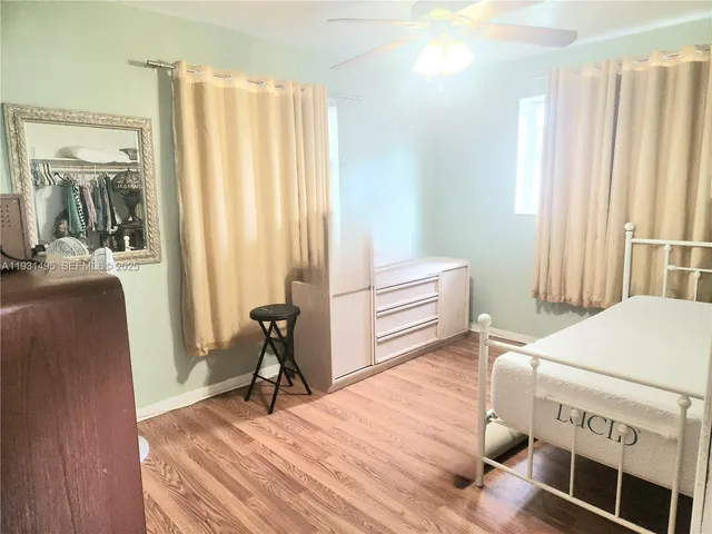 a bedroom with furniture and a window