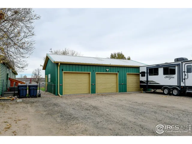 a kitchen with stainless steel appliances granite countertop a refrigerator a stove top oven a sink dishwasher and wooden cabinets with wooden floor