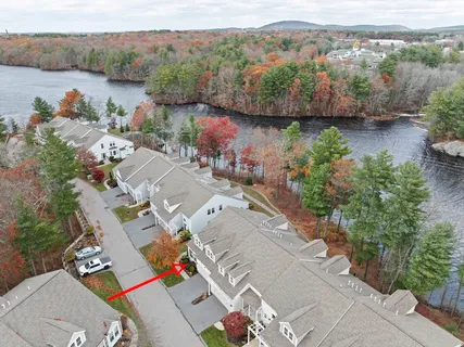 an aerial view of a house with a lake view