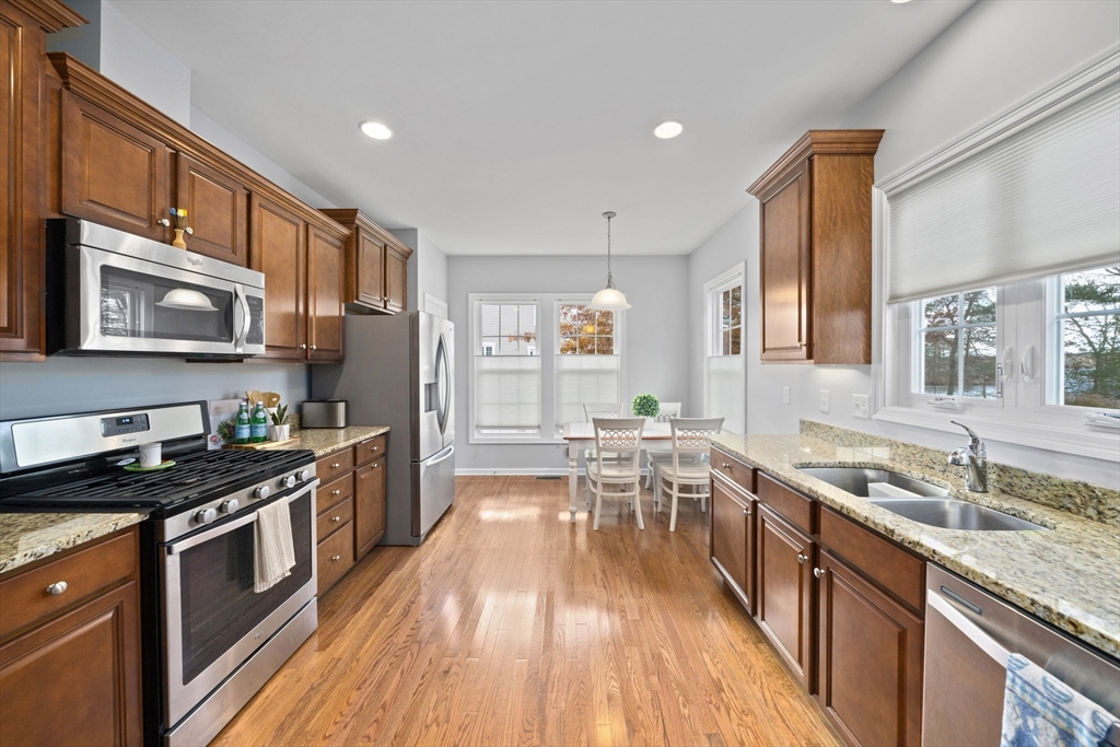 33 Kelly Way, Unit 33 Canton, MA 02021 - Photo 4 of 42 a kitchen with granite countertop a sink a counter top space stainless steel appliances and cabinets
